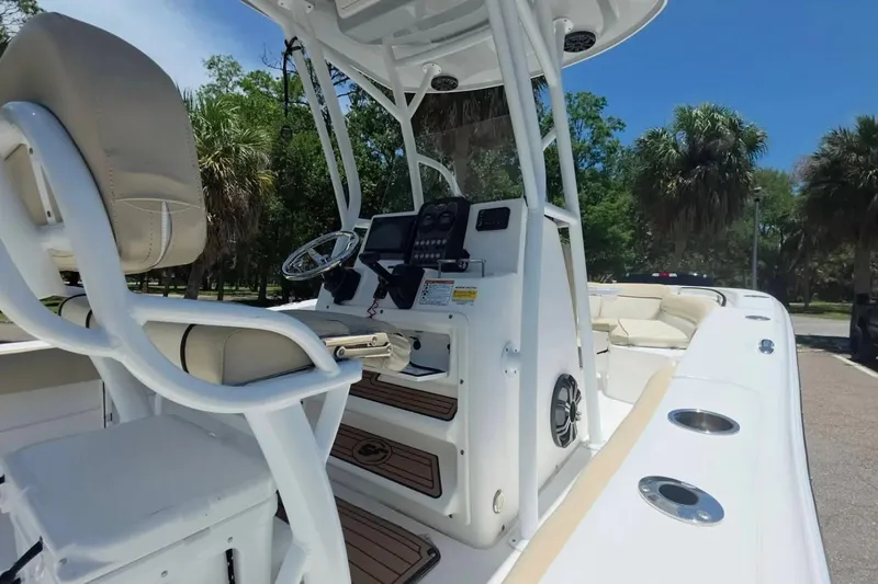 Slide: The Image of 2017 Sea Fox 226 Commander boat interior with helm, seating, and console under blue sky. - 16
