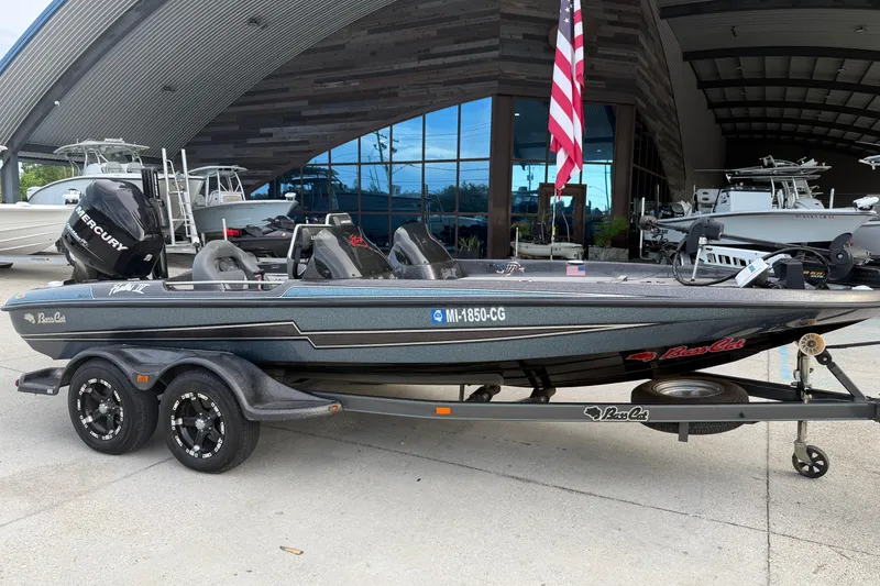 Slide: The Image of 2008 Bass Cat Pantera IV boat on trailer, displayed outdoors with American flag. - 2