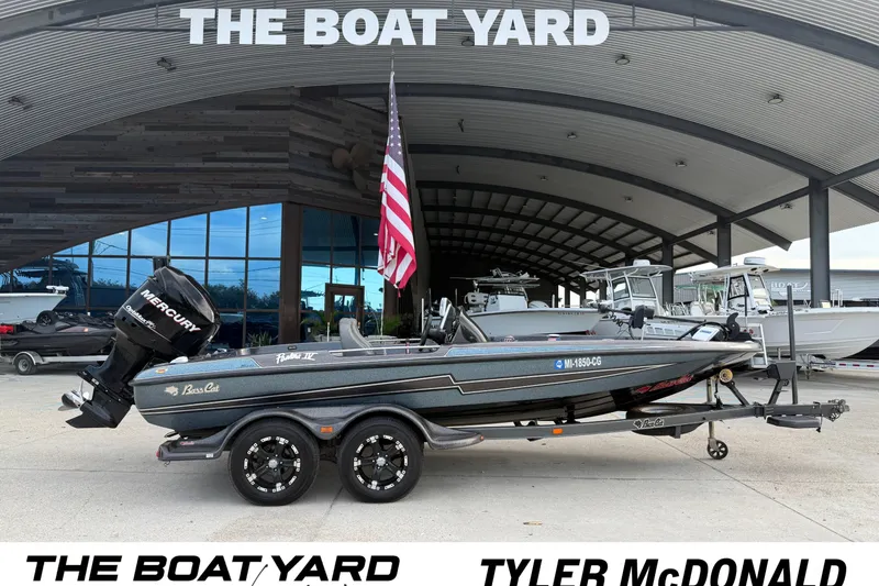 Slide: The Image of 2008 Bass Cat Pantera IV in front of a boat dealership with an American flag. - 9