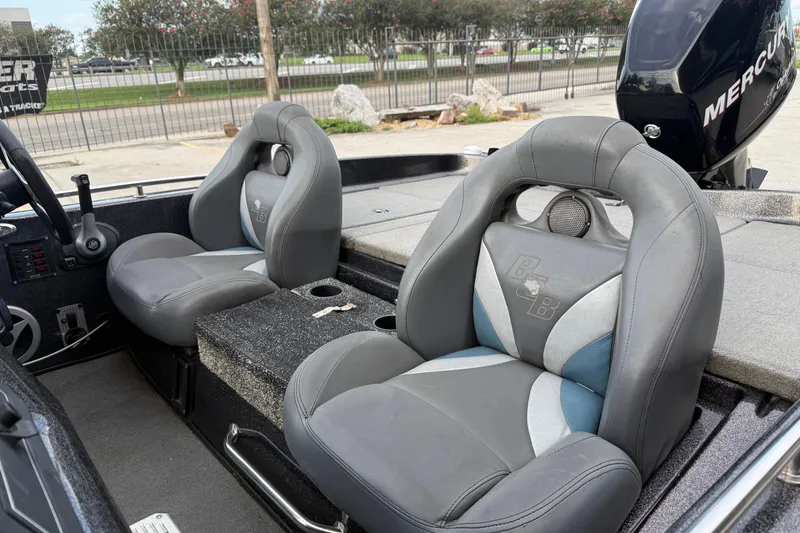 Slide: The Image of 2008 Bass Cat Pantera IV boat interior with gray seats and Mercury engine. - 12