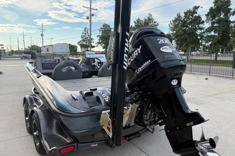 Slide: The Image of 2008 Bass Cat Pantera IV boat with Mercury OptiMax engine, parked outdoors. - 8