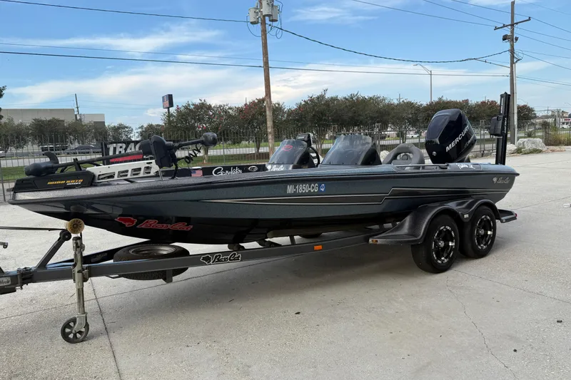 Slide: The Image of 2008 Bass Cat Pantera IV boat on trailer, parked outdoors under clear sky. - 6
