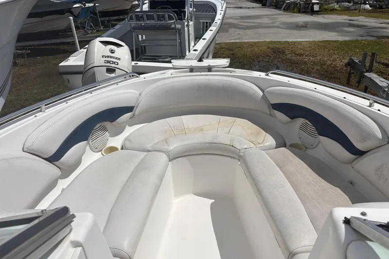 Slide: The Image of 2000 Chaparral 230 SSi boat interior with white seating and Evinrude 300 engine. - 20