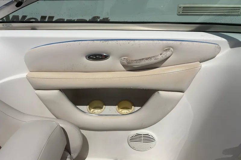 Slide: The Image of Interior of a 2000 Chaparral 230 SSi boat, featuring cup holders and speaker. - 24