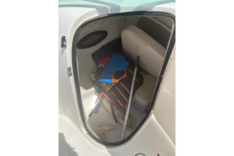 Slide: The Image of Storage compartment of a 2000 Chaparral 230 SSi boat with life jackets and equipment. - 23