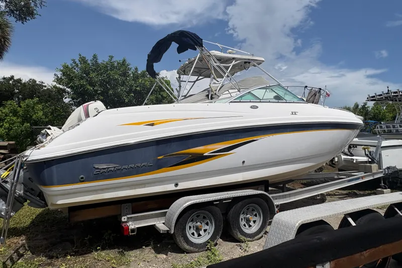 Slide: The Image of 2000 Chaparral 230 SSi boat on trailer, featuring sleek design and vibrant graphics. - 14