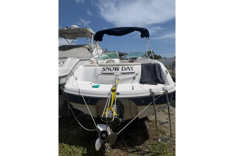 Slide: The Image of Chaparral 230 SSi 2000 boat named "Snow Day" docked under clear sky. - 16