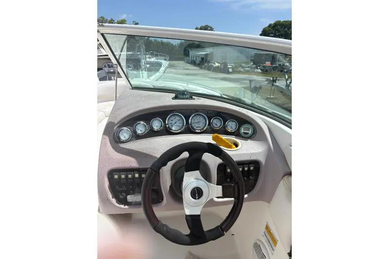 Slide: The Image of Dashboard of a 2000 Chaparral 230 SSi boat with steering wheel and gauges. - 21