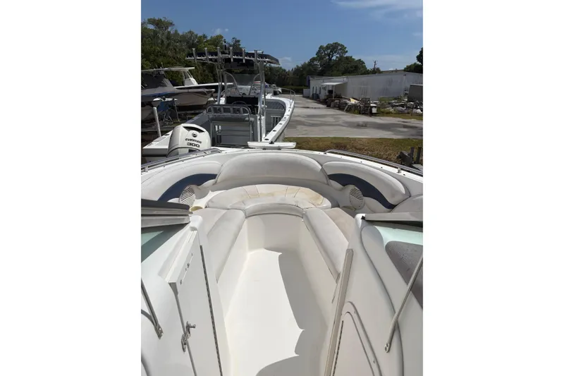 Slide: The Image of 2000 Chaparral 230 SSi boat interior with seating, parked outdoors. - 19