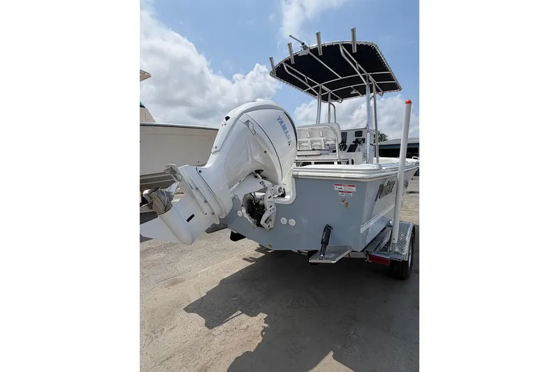 Slide: The Image of 2027 Parker 180 Coastal boat with Yamaha outboard motor on trailer, under blue sky. - 3