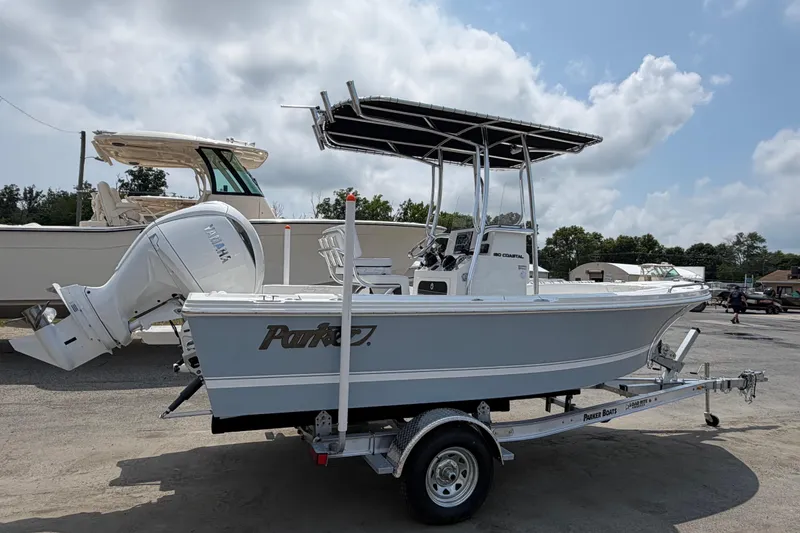 Slide: The Image of 2027 Parker 180 Coastal boat on trailer, featuring Yamaha outboard motor, parked outdoors. - 1