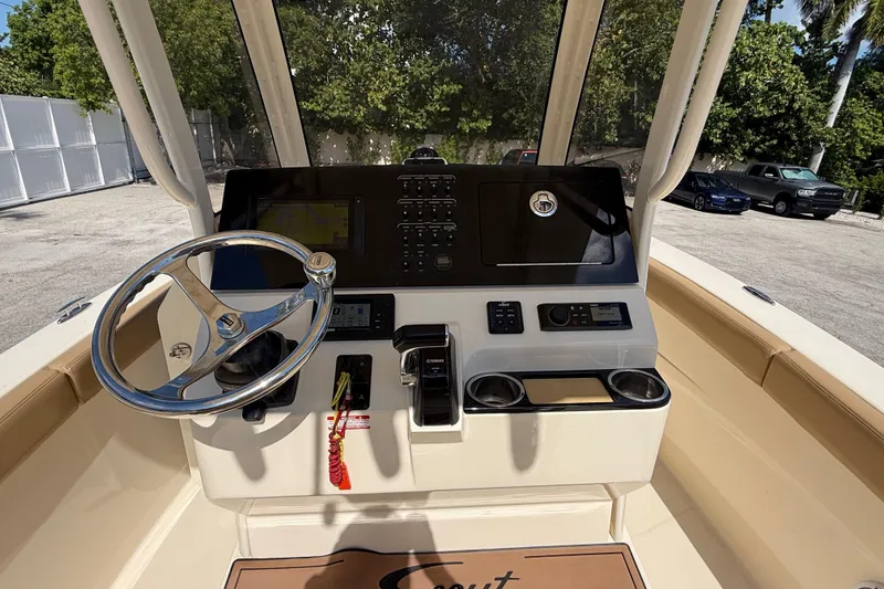 Slide: The Image of 2018 Scout 235 XSF boat console with steering wheel and navigation controls. - 7