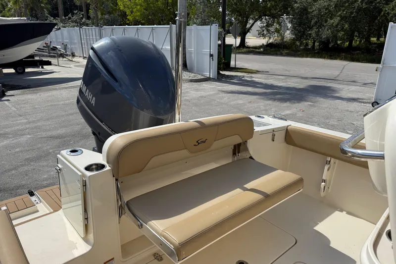 Slide: The Image of 2018 Scout 235 XSF boat with Yamaha outboard motor, featuring beige seating and cup holders. - 6