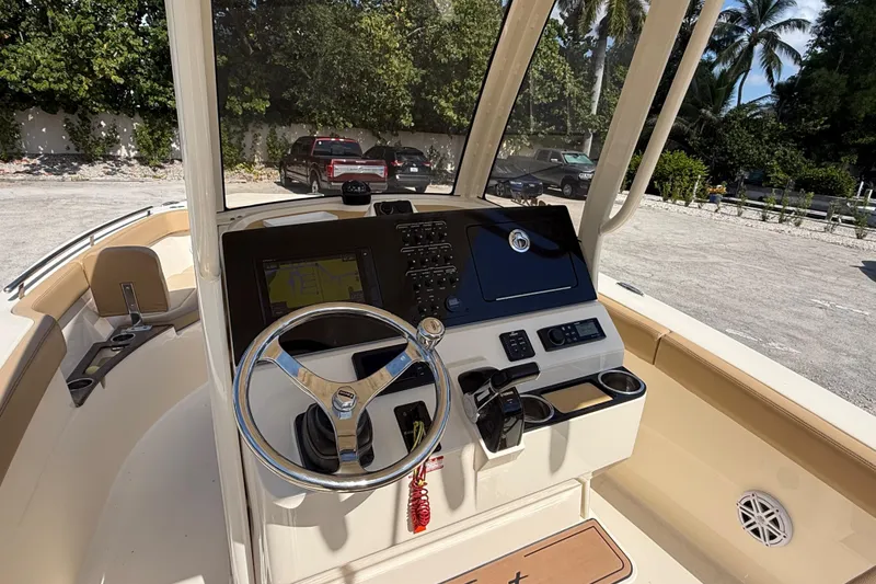 Slide: The Image of 2018 Scout 235 XSF boat dashboard with steering wheel and navigation controls. - 8