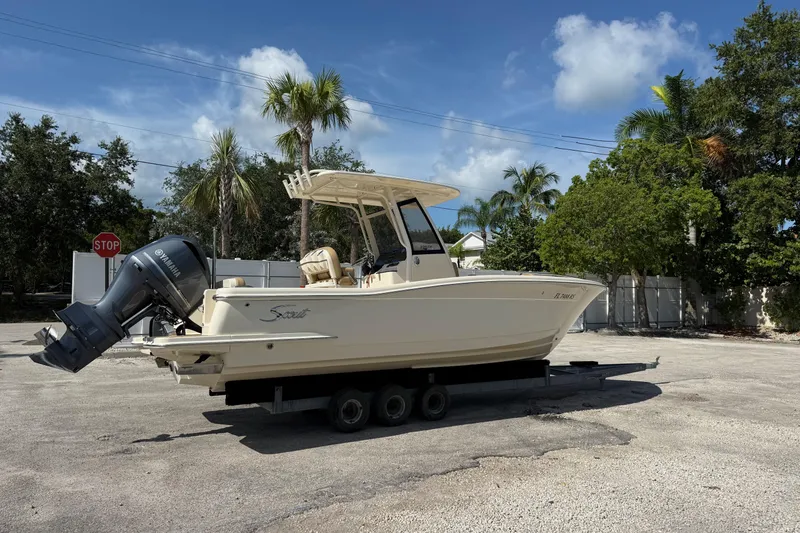 Slide: The Image of 2018 Scout 235 XSF boat with Yamaha engine on trailer, parked outdoors. - 3