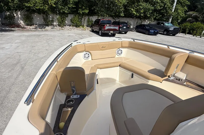 Slide: The Image of 2018 Scout 235 XSF boat interior with tan seating and cup holders. - 10