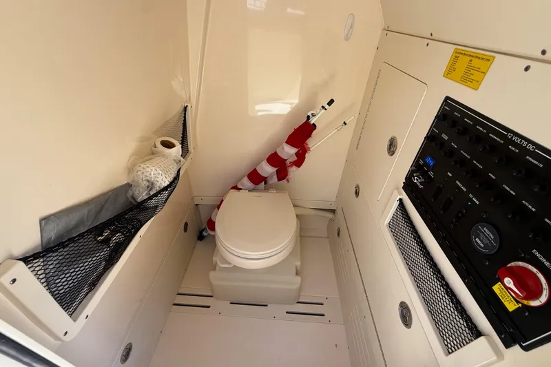 Slide: The Image of Interior of 2018 Scout 235 XSF boat with toilet and control panel. - 12