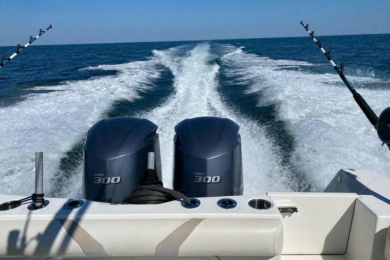 Slide: The Image of 2012 Sailfish 3180 CC boat with twin Yamaha 300 engines cruising on open water. - 4