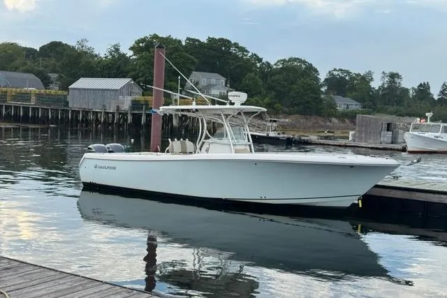 The Image of 2012 Sailfish 3180 CC boat docked at a serene marina. - 0