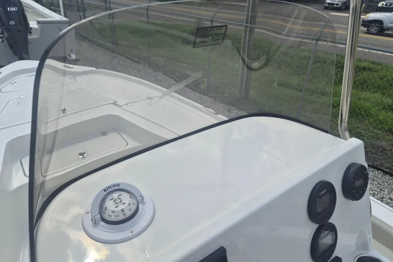 Slide: The Image of 2026 Key West 210 Bay Reef boat dashboard with compass and gauges. - 18