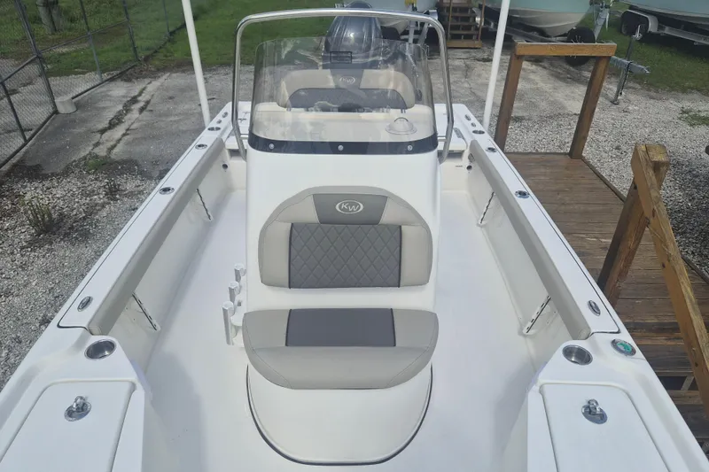 Slide: The Image of 2026 Key West 210 Bay Reef boat interior with cushioned seating and console. - 14