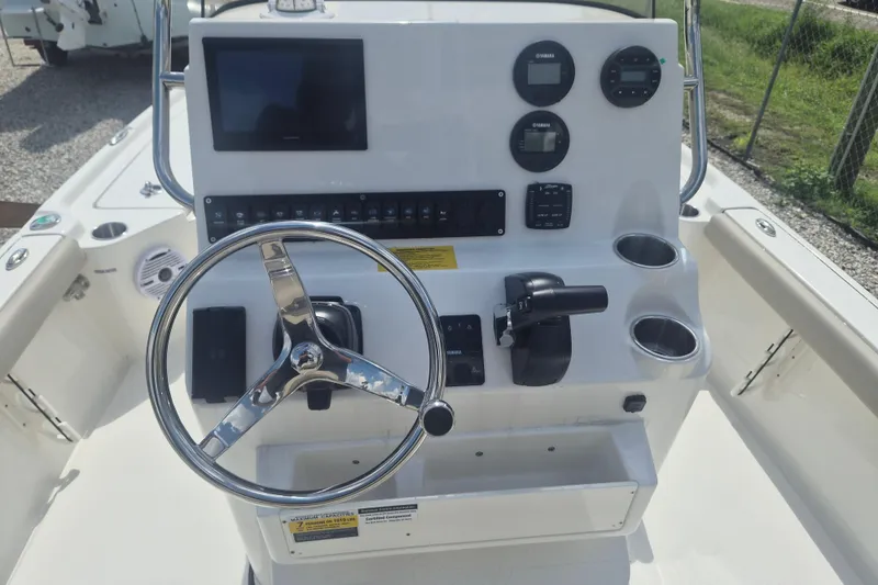 Slide: The Image of 2026 Key West 210 Bay Reef boat console with steering wheel and control panel. - 10