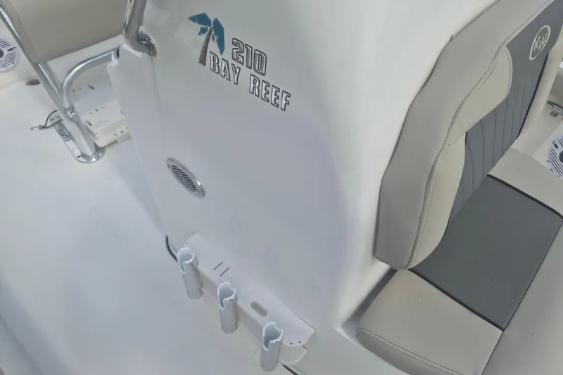 Slide: The Image of 2026 Key West 210 Bay Reef boat interior with seating and logo detail. - 15
