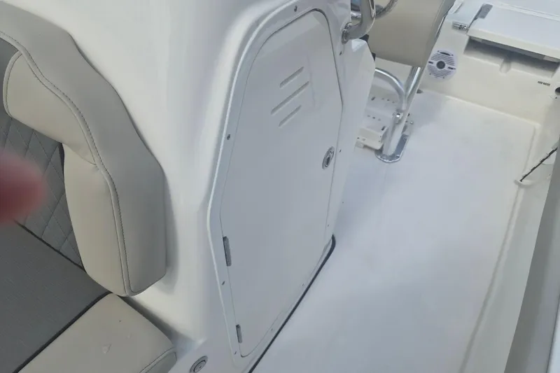 Slide: The Image of Interior view of a 2026 Key West 210 Bay Reef boat, featuring seating and storage. - 16