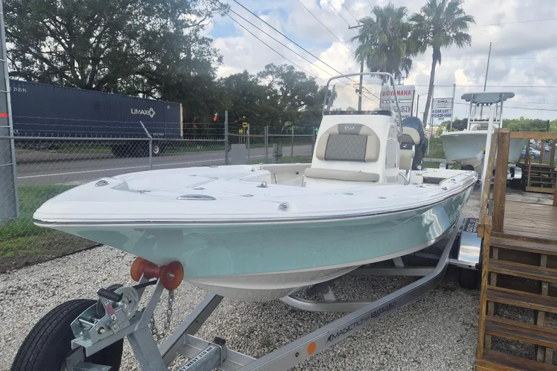 Slide: The Image of 2026 Key West 210 Bay Reef boat on trailer, displayed outdoors near dealership. - 5