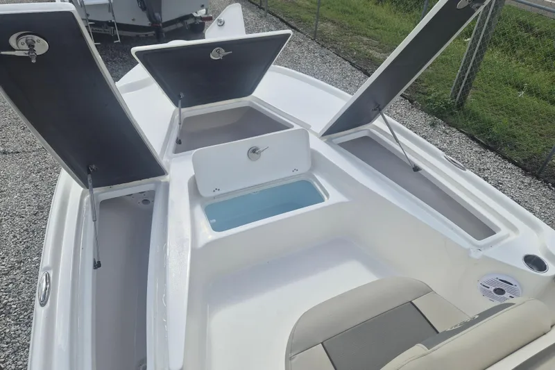 Slide: The Image of 2026 Key West 210 Bay Reef boat with open storage compartments and seating area. - 12
