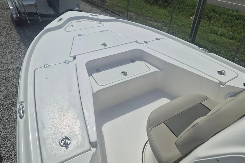 Slide: The Image of 2026 Key West 210 Bay Reef boat deck with storage compartments and seating. - 11