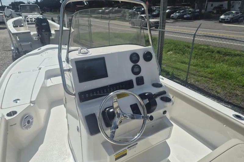 Slide: The Image of 2026 Key West 210 Bay Reef boat dashboard with steering wheel and controls. - 8