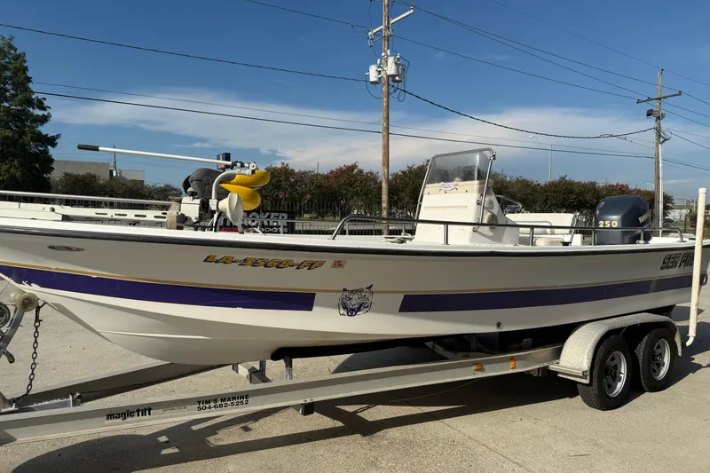 Slide: The Image of 2002 Sea Pro SV2400CC Bay Boat on trailer, parked outdoors under clear sky. - 6