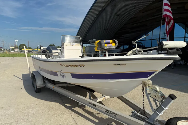 Slide: The Image of 2002 Sea Pro SV2400CC Bay Boat on trailer, parked outdoors under clear sky. - 4
