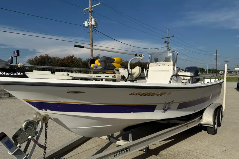Slide: The Image of 2002 Sea Pro SV2400CC Bay Boat on trailer, parked outdoors under clear sky. - 5