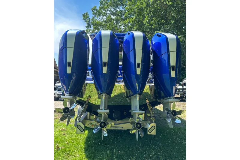Slide: The Image of Four powerful outboard motors on a 2025 Nor-Tech 390 Sport Center Console boat. - 9