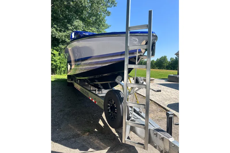 Slide: The Image of 2025 Nor-Tech 390 Sport Center Console boat on trailer, parked outdoors. - 8