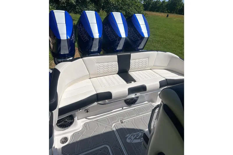Slide: The Image of 2025 Nor-Tech 390 Sport Center Console with luxurious seating and powerful outboard engines. - 7
