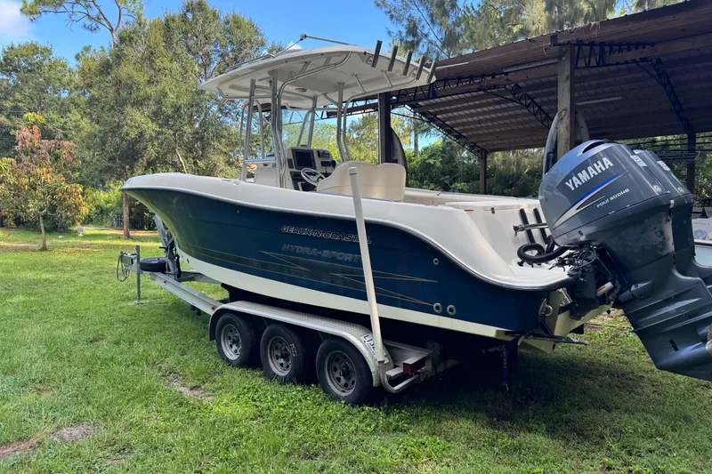 Slide: The Image of 2007 Hydra-Sports Vector 2500 CC boat on trailer with Yamaha engine, parked outdoors. - 2