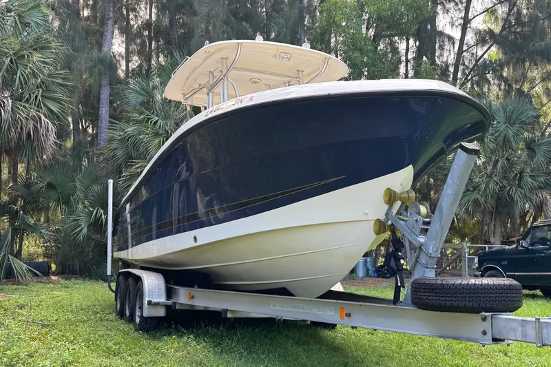 Slide: The Image of 2007 Hydra-Sports Vector 2500 CC boat on trailer, surrounded by lush greenery. - 5