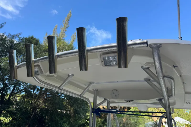 Slide: The Image of 2007 Hydra-Sports Vector 2500 CC boat with rod holders and canopy against blue sky. - 13