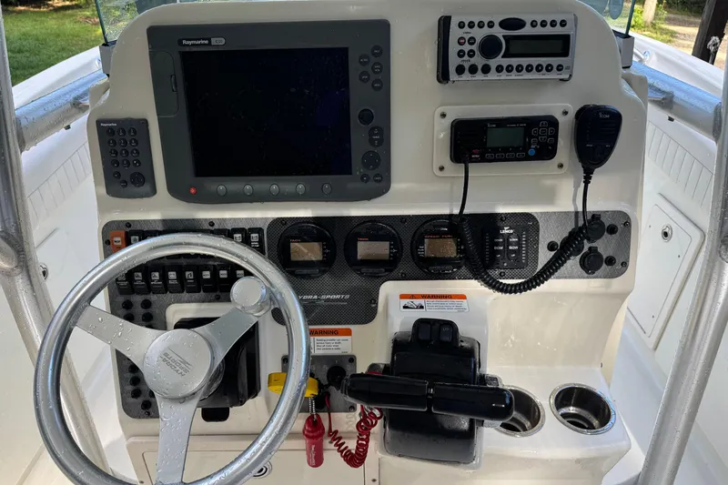 Slide: The Image of 2007 Hydra-Sports Vector 2500 CC boat dashboard with steering wheel and navigation controls. - 14