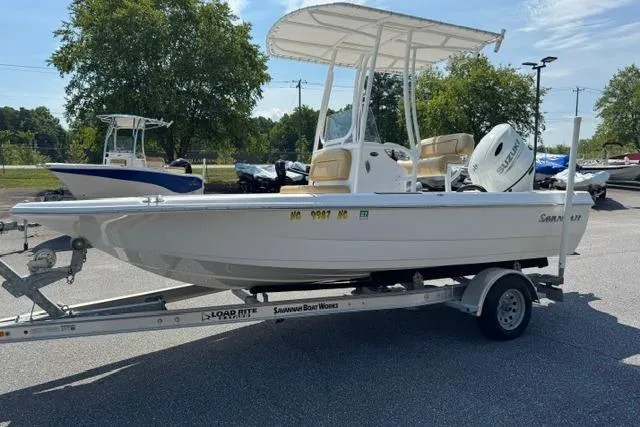 Slide: The Image of 2022 Savannah 190 IS boat on trailer, parked outdoors under clear sky. - 3