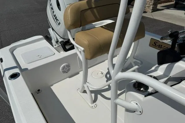 Slide: The Image of 2022 Savannah 190 IS boat interior with tan seating and Suzuki engine. - 9