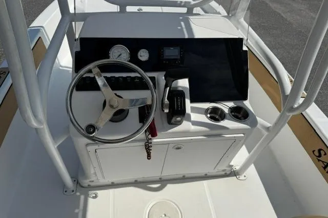 Slide: The Image of 2022 Savannah 190 IS boat console with steering wheel and controls. - 13
