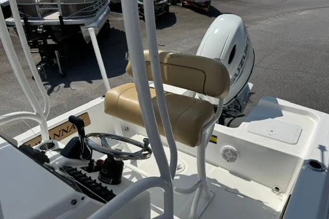 Slide: The Image of 2022 Savannah 190 IS boat interior with steering wheel and seating. - 10