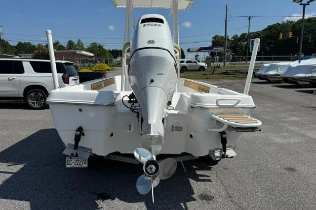 Slide: The Image of 2022 Savannah 190 IS boat with outboard motor, parked in a lot on a sunny day. - 4
