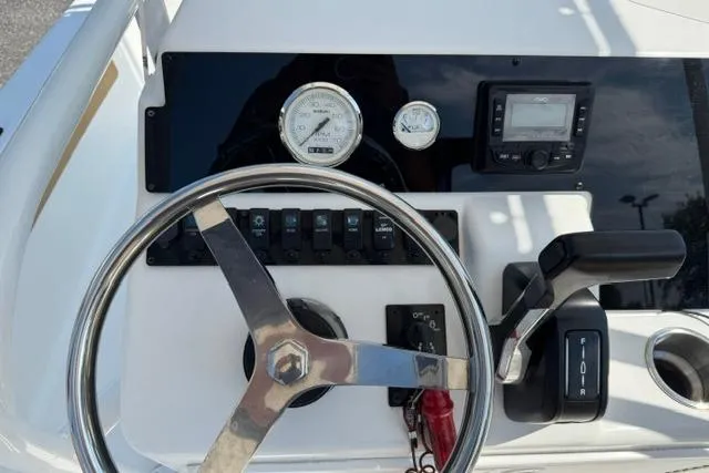 Slide: The Image of Steering console of 2022 Savannah 190 IS boat with gauges and controls. - 14