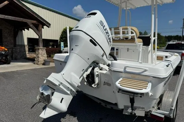 Slide: The Image of 2022 Savannah 190 IS boat with Suzuki outboard motor, parked outdoors. - 5