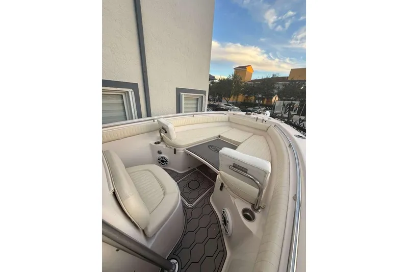 Slide: The Image of 2004 Grady-White Chase 273 boat interior with cushioned seating and modern design. - 6